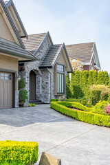 Entrance of painted luxury house in spring with stair steps and nice landscape in Vancouver, Canada, North America. Day time on May 2025.