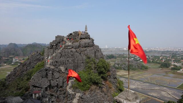 Stone Path to the Top of Mua Caves in Ninh Binh Vietnam with National Flags and Mountain View