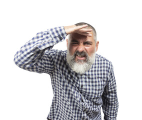 Obraz premium Bearded mature man shielding his eyes with his hand while searching the horizon on a sunny day