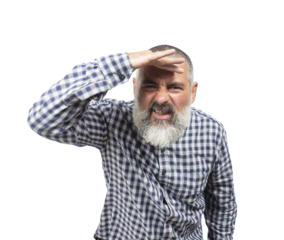 Bearded mature man shielding his eyes with his hand while searching the horizon on a sunny day