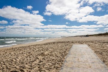 a footbridge on the beach in the seaside town of Władysławowo