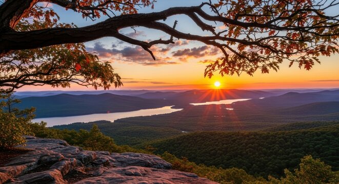 A breathtaking sunset paints the sky with vibrant orange and blue hues over a majestic mountain range and winding river - Powered by Adobe