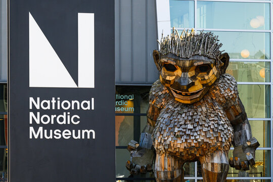 Seattle - March 7, 2025; Frankie Feetsplinter with National Nordic Museum sign in Ballard neighborhood artist Thomas Dambo