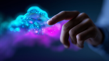 A human hand reaches out to touch an abstract, glowing cloud made of blue and pink particles, symbolizing cloud computing or AI interaction.
