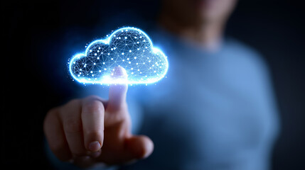 A business person's hand reaches out to touch a glowing blue, abstract cloud icon, representing cloud computing or data.
