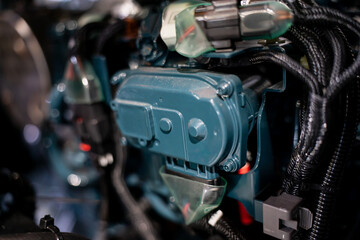 Fototapeta premium Industrial diesel engine components with protective wiring and connectors, modern machinery detail for power generation, mechanical systems and heavy equipment applications
