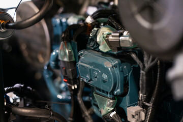Obraz premium Detailed view of industrial diesel engine with wiring, connectors and metallic components, modern mechanical system used in heavy equipment, machinery power units and engineering applications