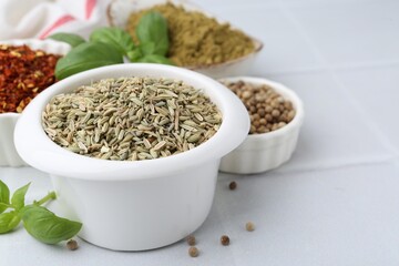 Different aromatic spices on white tiled table, closeup