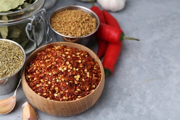 Different aromatic spices on grey table, closeup. Space for text