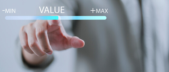 The concept of increasing marketing value, growth, and product value a business growth concept. A businessman moves virtual bar to MAX level.
