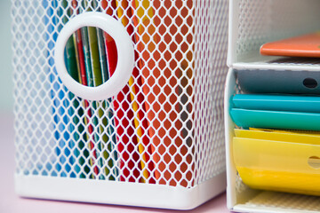 Office supplies on a pink background. Close-up. Selective focus.