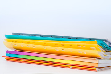 Stack of colorful folders on white background. Copy space for text.