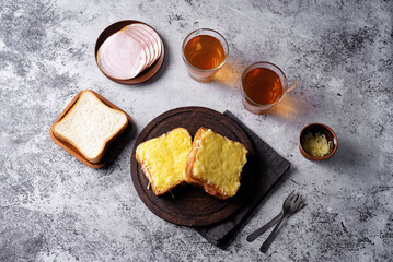Ham cheese sandwich on a wood plate