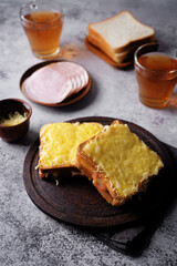 Ham cheese sandwich on a wood plate