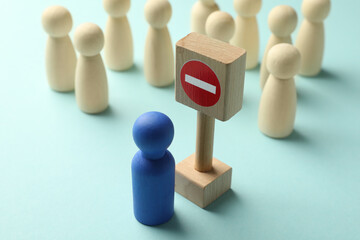 Unemployment. Human figures and stop sign on light blue background, closeup