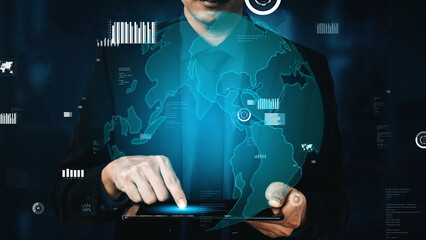 Close-up of a professional man interacting with a tablet showing a global map and data...