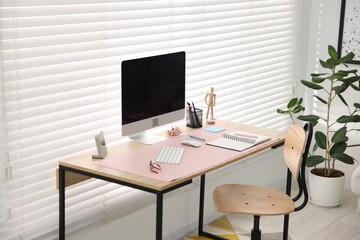 Stylish workplace with wooden desk, stationery and computer at home office. Interior design