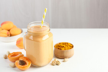 Superfood. Tasty smoothie and ingredients on white table, closeup. Space for text