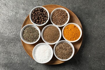 Different aromatic spices on grey table, top view