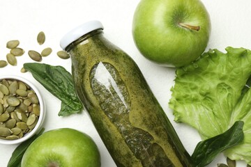 Superfood. Tasty smoothie in glass bottle and ingredients on white table, flat lay