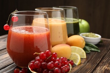 Superfood. Tasty smoothies in glasses and ingredients on wooden table, closeup