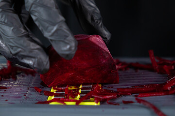 Person wearing protective black gloves grating fresh red beet root for healthy cooking preparation, emphasizing safety and vibrant ingredients