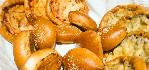 Natural baked goods in a basket. Muffins, buns. Fresh flour products.