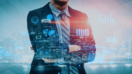 A businessman in a suit stands confidently with crossed arms against a digital city background. Data visualizations and graphs illustrate growth and analysis in a futuristic environment. Xenic