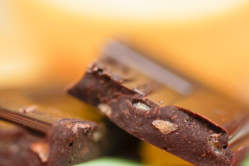 A broken chocolate bar revealing the filling the filling consists of caramel or small pieces of...