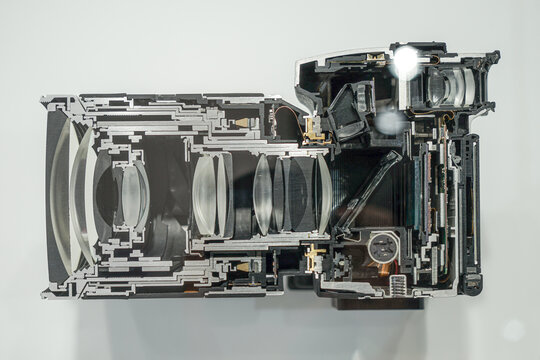 The mechanism of a modern digital camera in section including the lens.