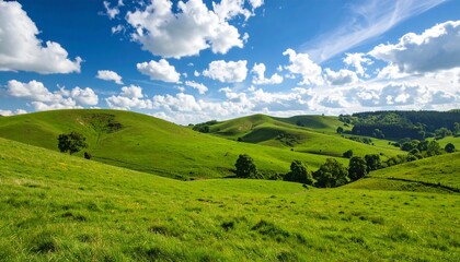 Naklejka premium Rolling green hills under a bright blue sky with scattered fluffy clouds, peaceful rural setting, panoramic view