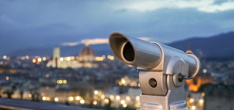 A close up view of a viewing tube with the city of Florence in Tuscany, Italy, in the background