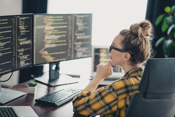 Young Woman Programmer Working at Her Desktop with Focus on Coding in a Professional Modern...
