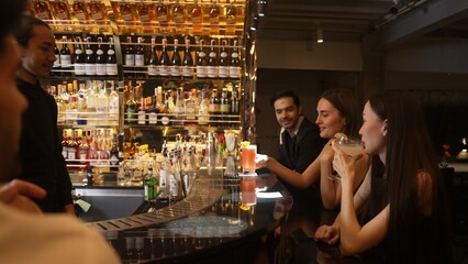 Beautiful woman with Paloma cocktail drinks smoothy making cheers with friend holding Margarita...