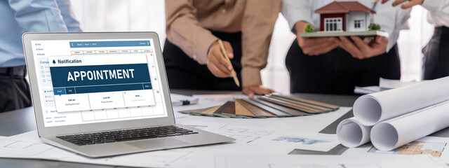 Group of interior architect designer discussing together on blueprint and laptop screen display...