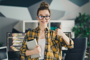 Young professional female programmer smiling confidently in a modern home office with technology...