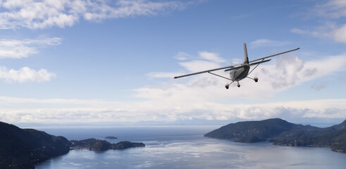 Light Aircraft Flying Over ocean and Coastal Landscape on a Clear Day