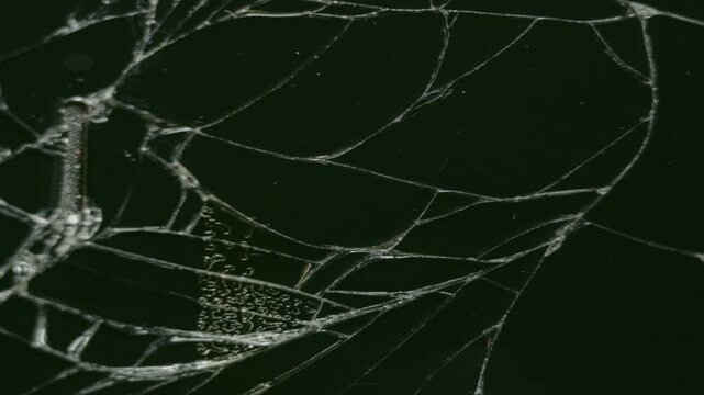 Slow-motion sequence of glass shattering against a black background for visual effects compositions. Crack Animation that looks like glass. footage of broken glass, crack screen glass.