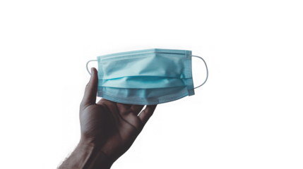 A persons hand holds up a light blue disposable medical face mask offering protection against a transparent background