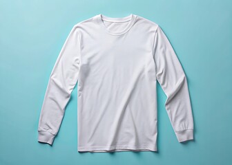 Plain white long sleeve t shirt laid flat on a teal background