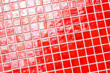 Mosaic of scratched glass tiles as a decorative element in architecture. Antique square red tile.