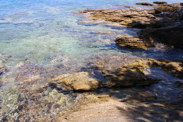 Rocky sea coast with clear turquoise ocean water, Murter, Croatia