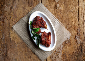 Delicious Spicy Fried Chicken Pieces on Rustic Wooden Background