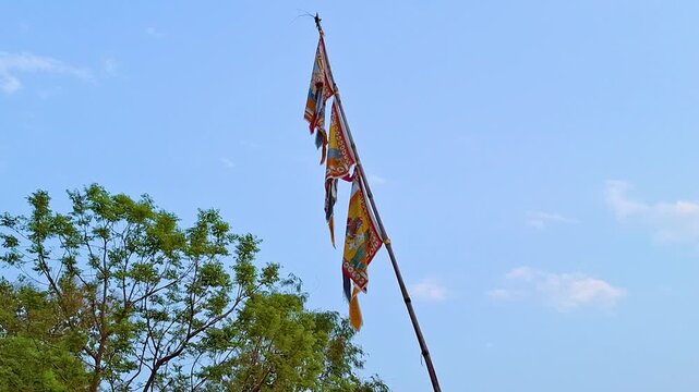 4K Video of Colorful Buddhist Prayer Flags Waving in the Wind Against a Clear Blue Sky