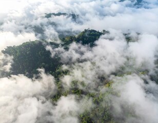 Fototapeta premium Aerial View of Verdant Forested Mountain Landscape Shrouded in White Mist and Cloud