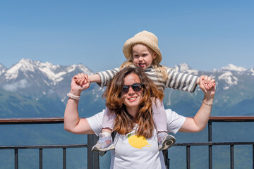 A young mother with her three-year-old child daughter goes to the mountains on Rosa Khutor in Sochi...