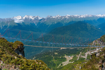 A suspension bridge in the mountains between two peaks, an extreme attraction for travelers, Rosa...