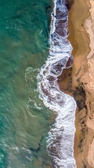 Aerial View of Sandy Beach Meeting Turquoise Water Ocean with Foamy Waves