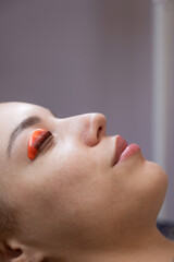 Caucasian woman undergoing eyelash lamination procedure. 