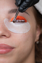 Caucasian woman undergoing eyelash lamination procedure. 